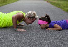 An Old woman does push ups with a kid