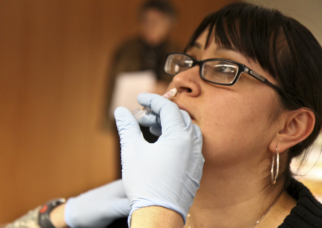 Woman receives seasonal flu shot