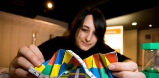 A girl holding a model of dna