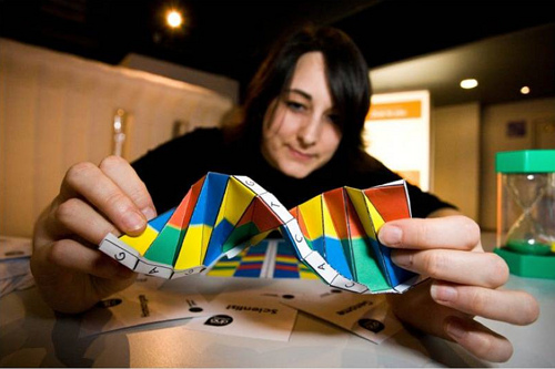 A girl holding a model of dna