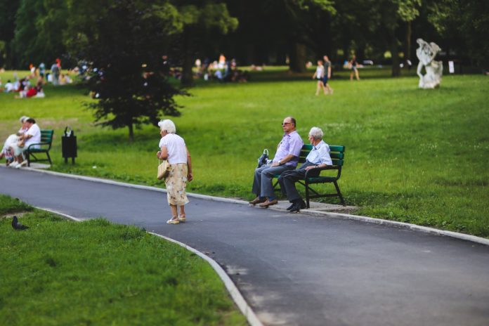 An old woman taking a walk in park