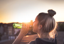 A teen girl drinking beer