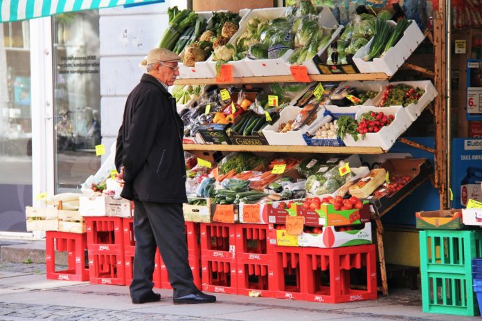 An old man at a fruits stall in Europe