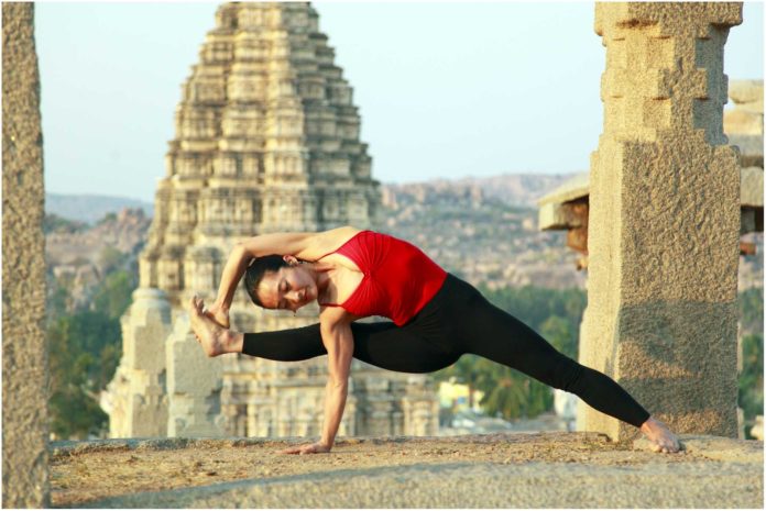 Lady practising yoga at Veerupaksha temple
