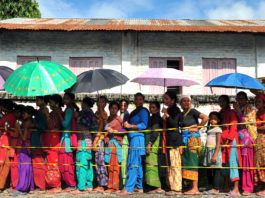People wait outside a health centre