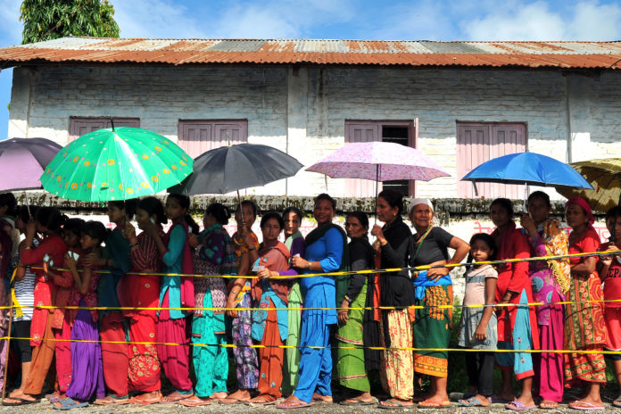 People wait outside a health centre