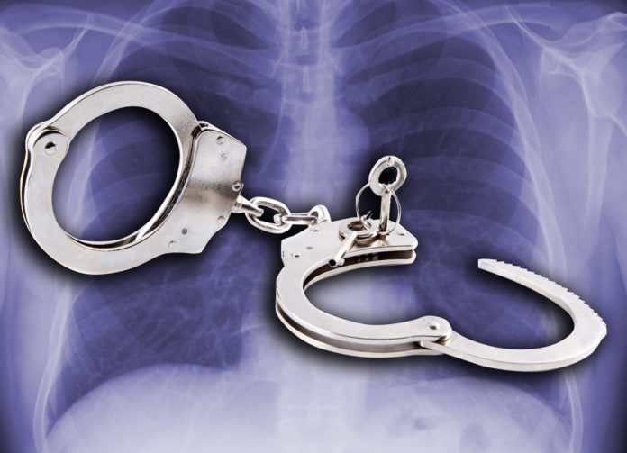 Handcuffs against a background of chest X ray