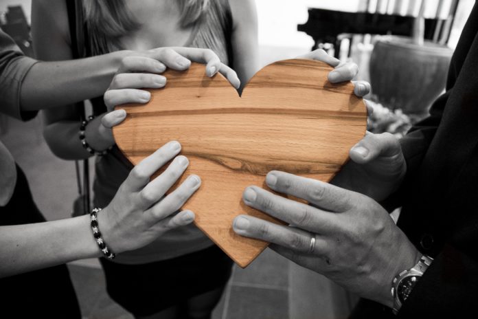 Hands holding a symbol of heart