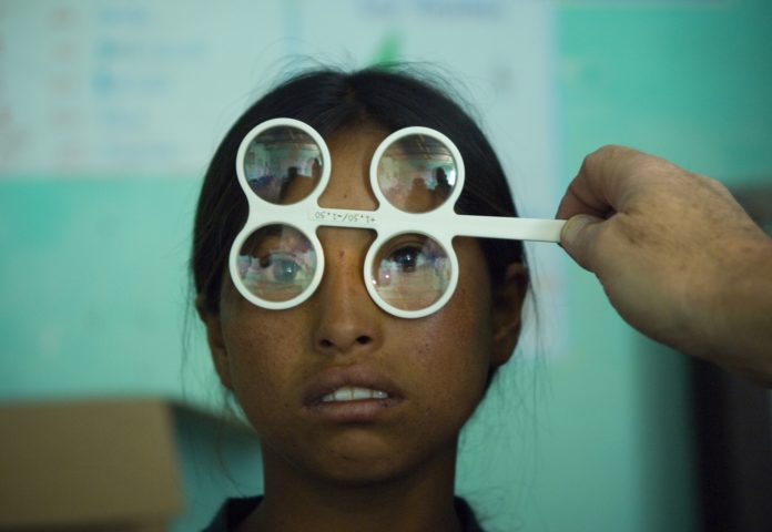 Poor girl getting eyesight test