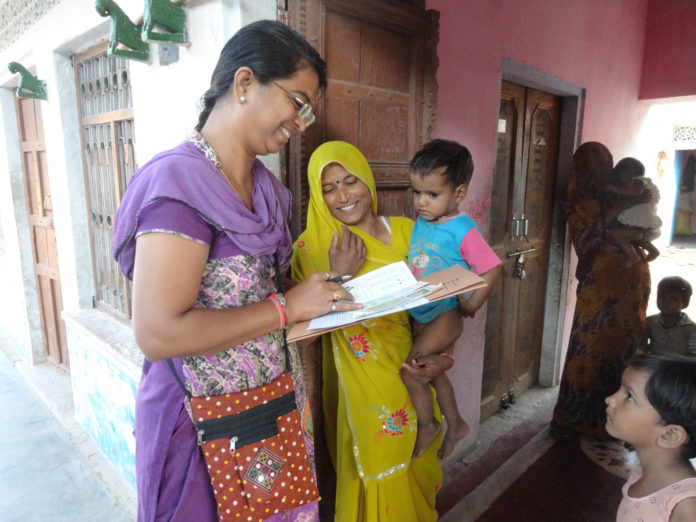 health worker collecting details of aayushman Bharat
