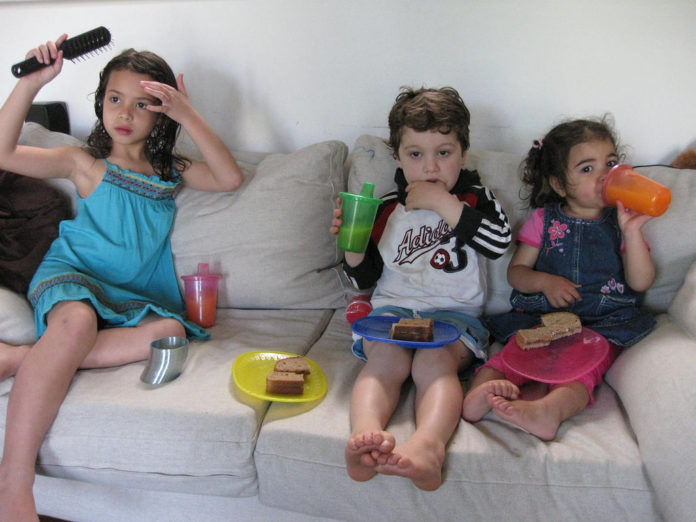 Kids watching TV and having junk food