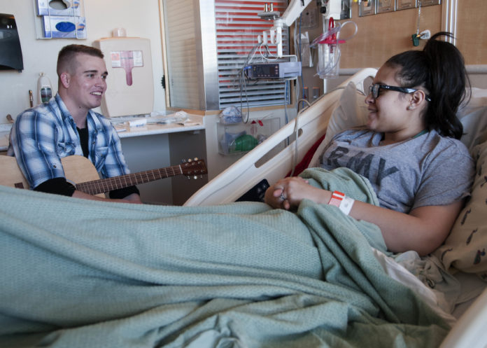 A patient recovering after surgery by listening to music