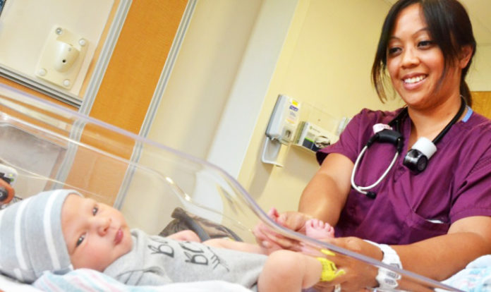 nurse examines a newborn