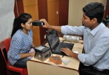 A lady gets her iris scanned for Aadhar card