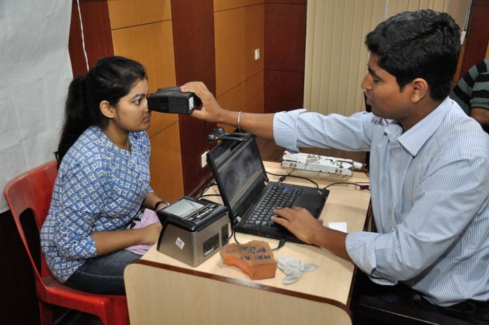 A lady gets her iris scanned for Aadhar card